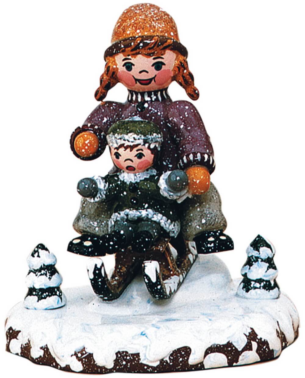 Winterkind Schlittenfahrerin